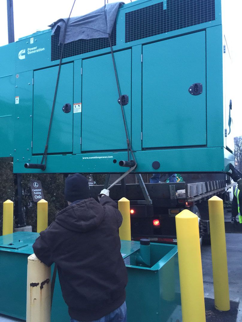 A man is standing next to a large green box with the letter c on it