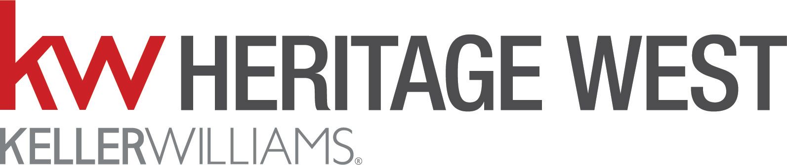 Couple sitting amidst cardboard boxes, resting in a new home, looking at each other.