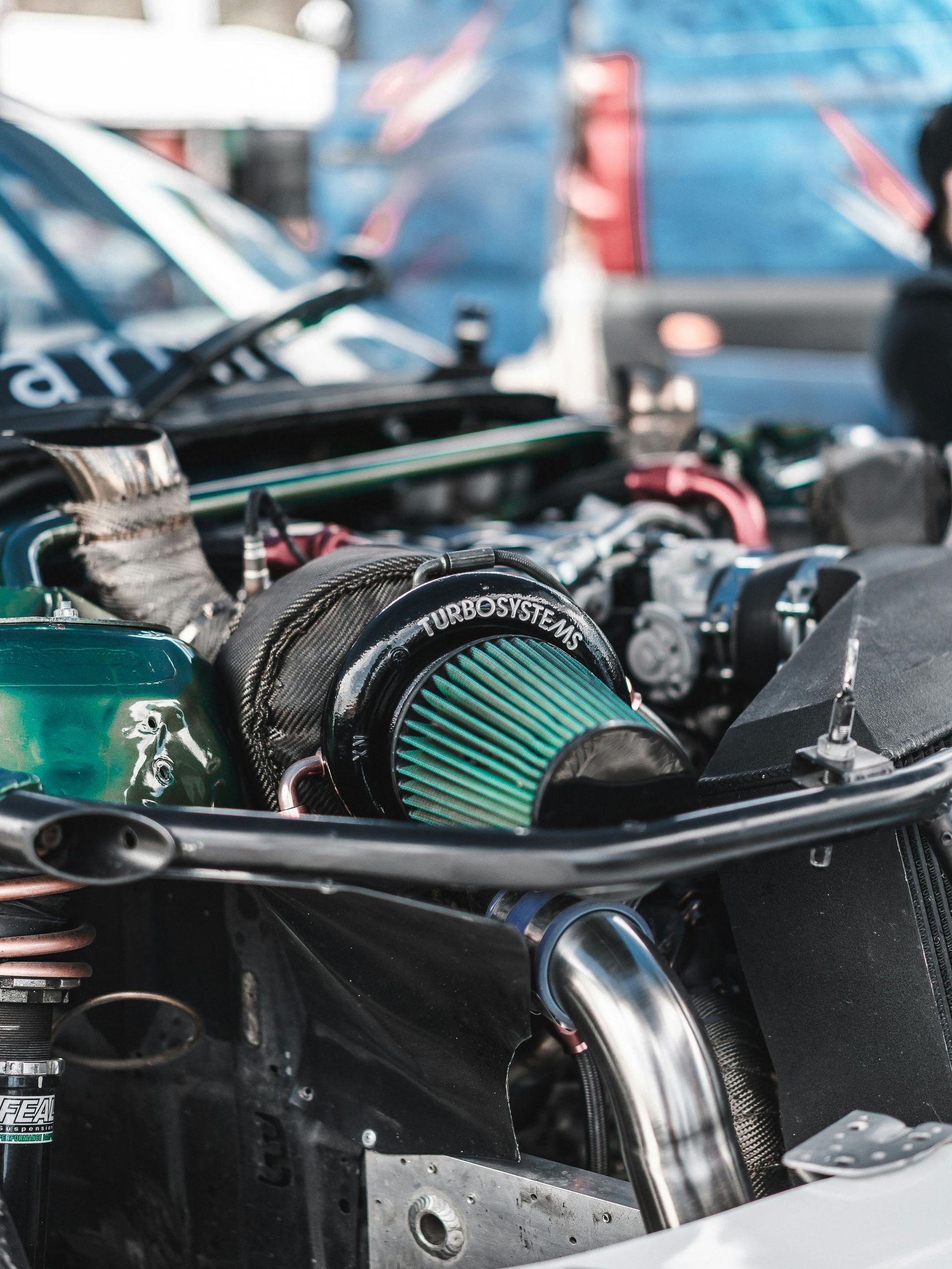 Engine bay of a modified car, featuring a green air filter