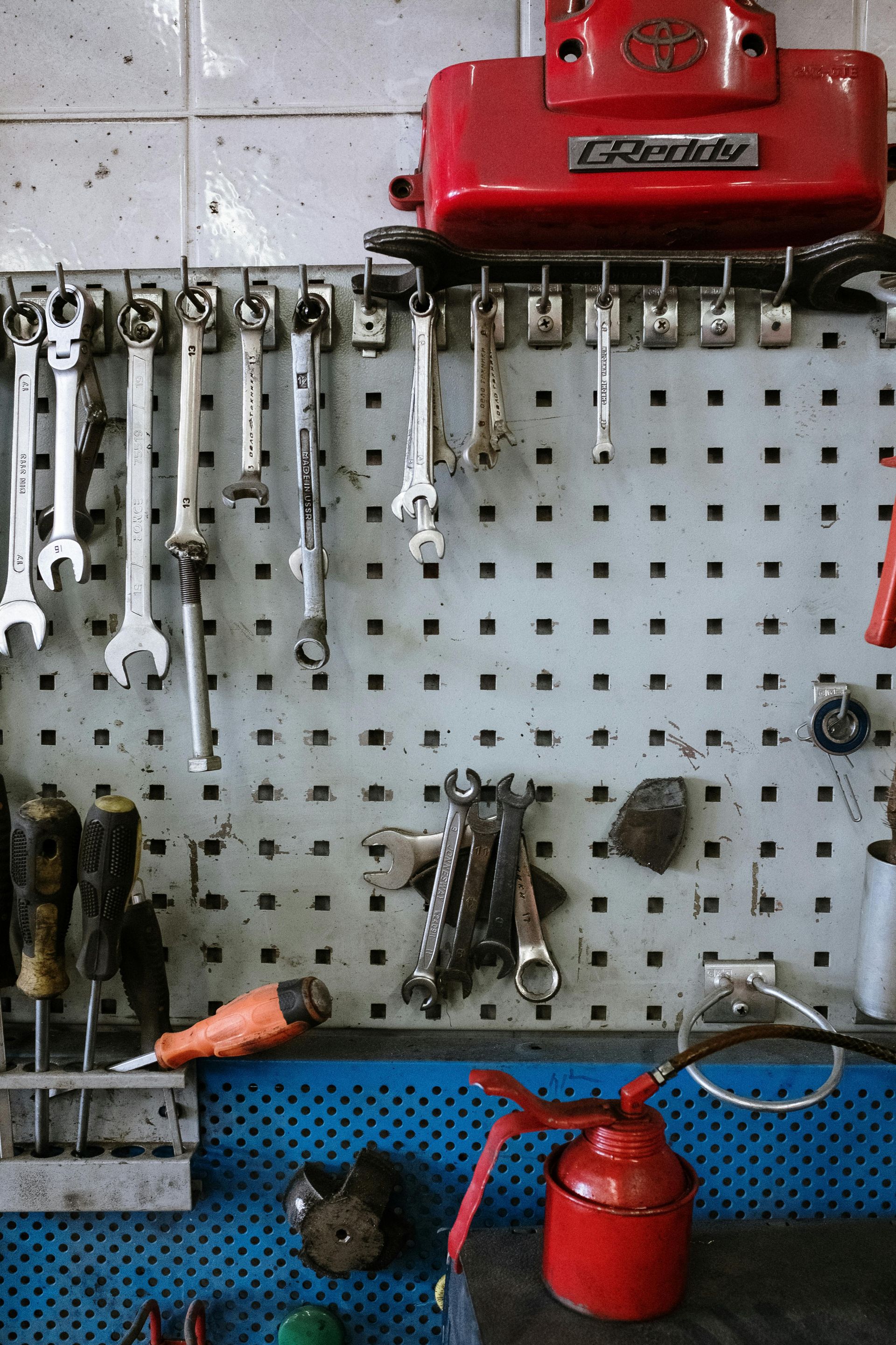 A wall with tools hanging on it