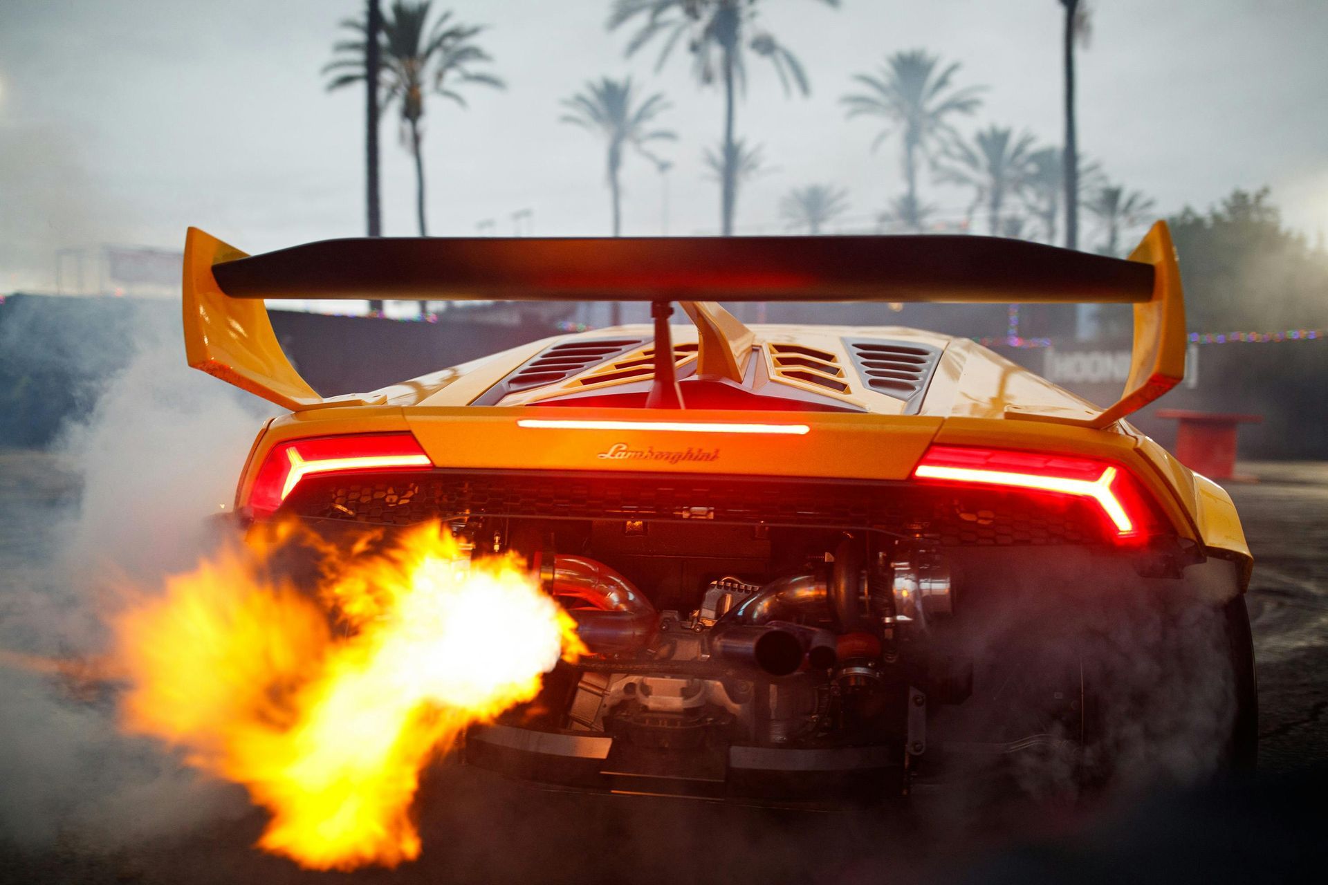 Yellow Lamborghini with flames erupting from the exhaust.