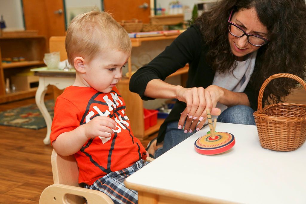 Montessori guide and child in the classroom