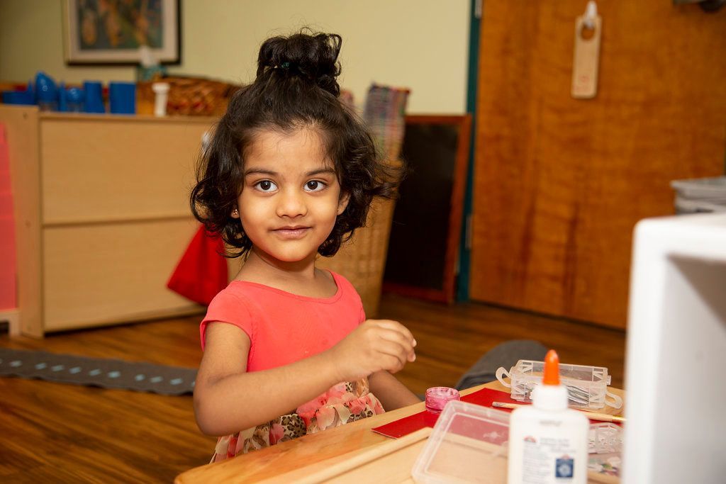 Montessori child working on a craft