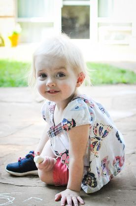 Montessori child smiling at the camera