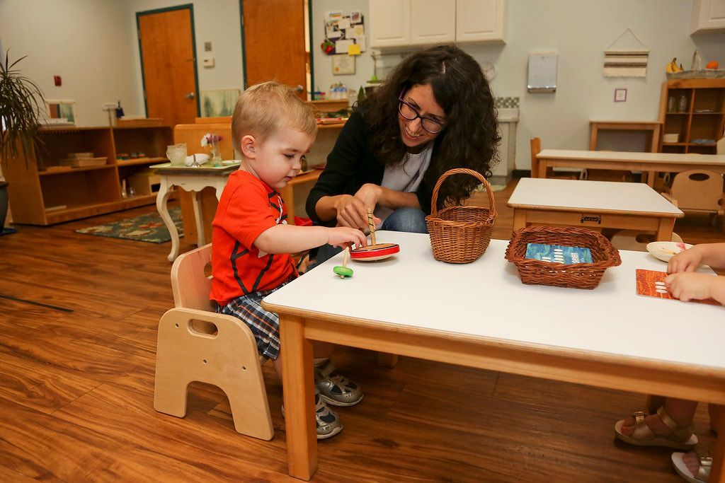 Montessori guide and student in the classroom