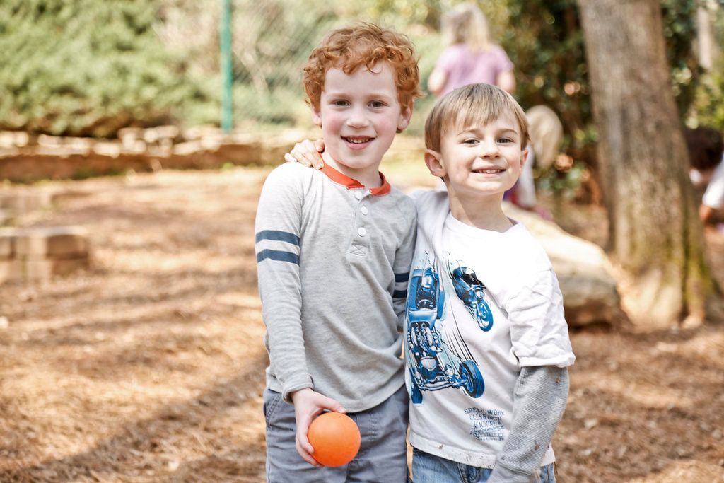 Montessori children smiling at the camera