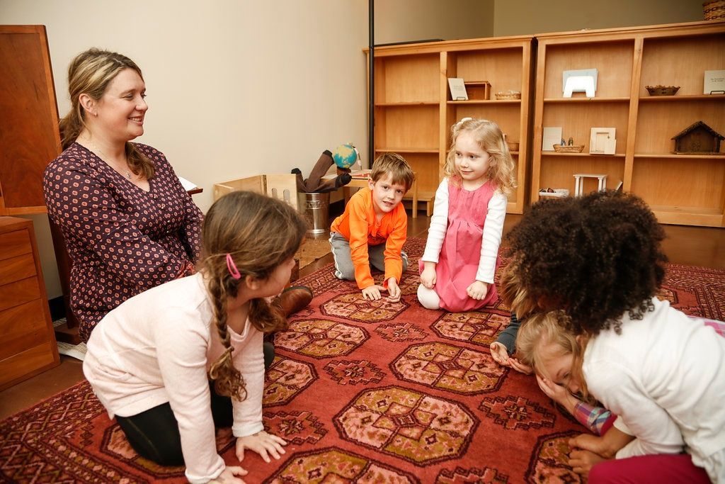 Montessori guide and children singing a song