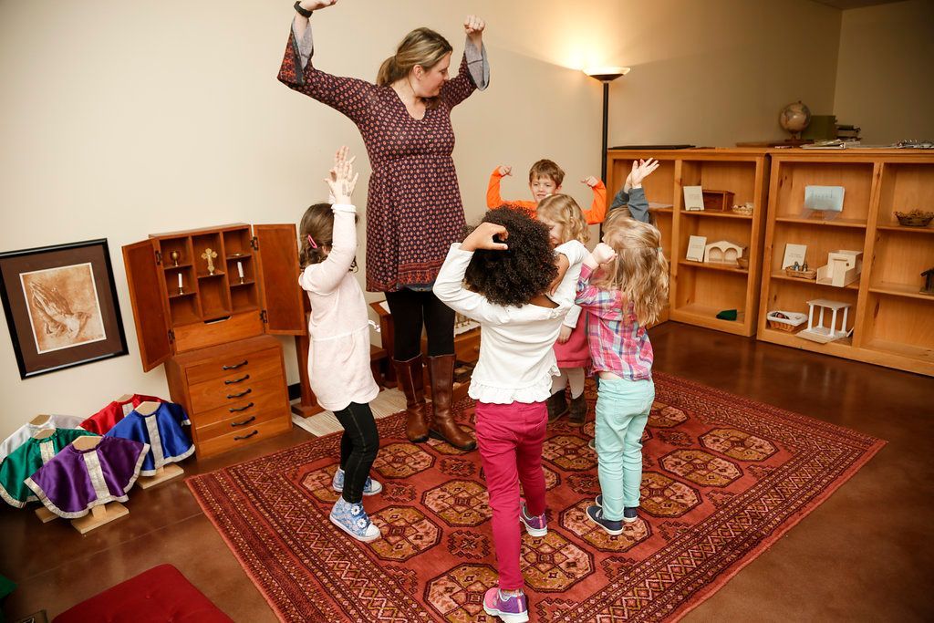 Montessori guide and children singing a song