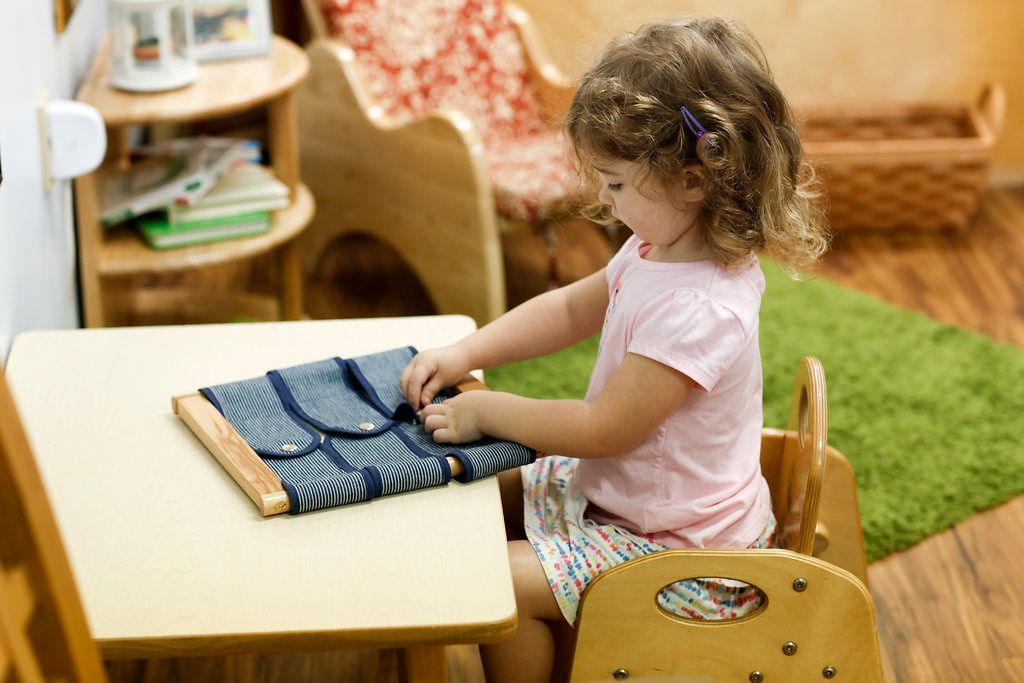 Montessori child working with practical life materials