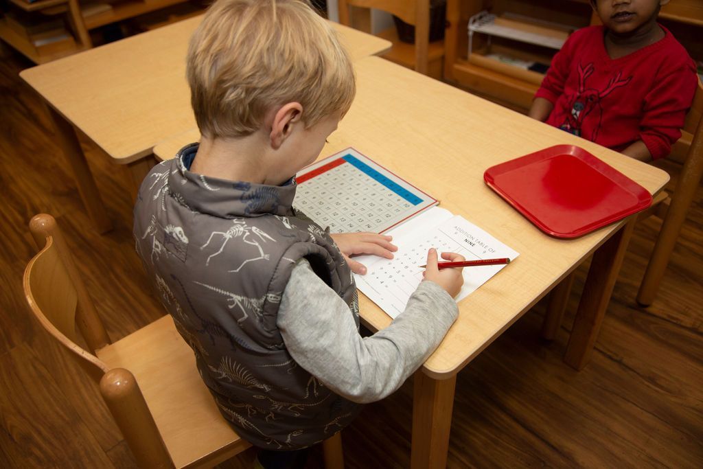 Child working with Montessori math materials