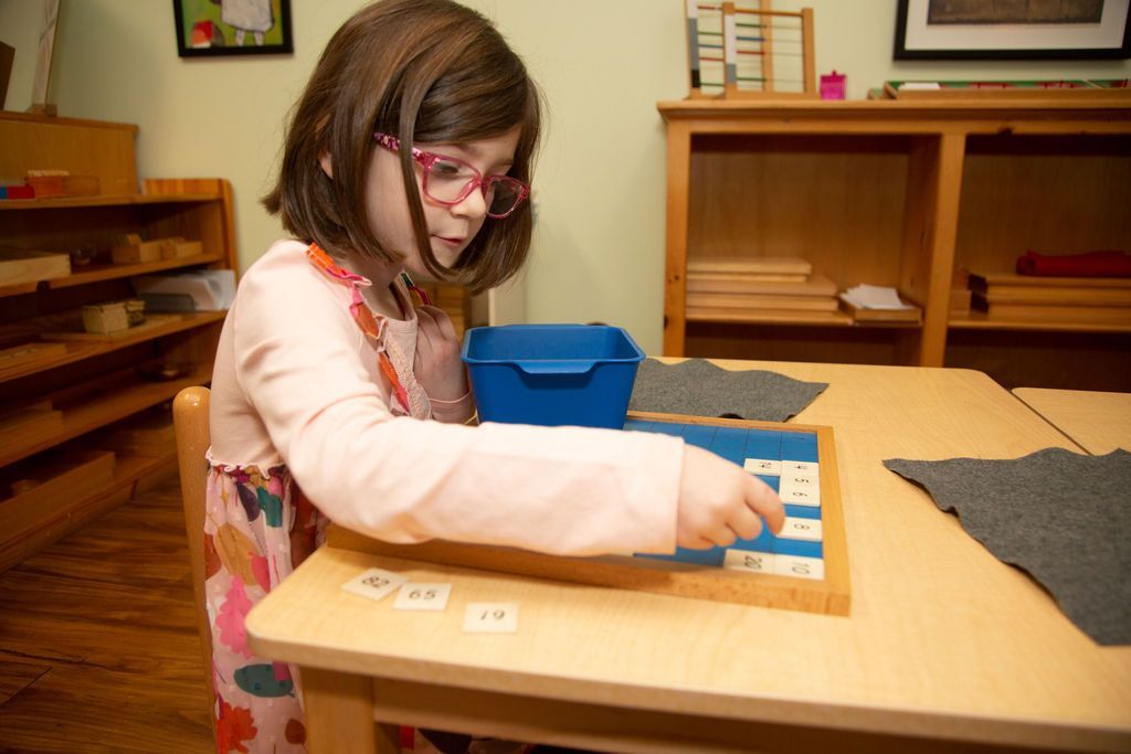 Child working with Montessori math materials