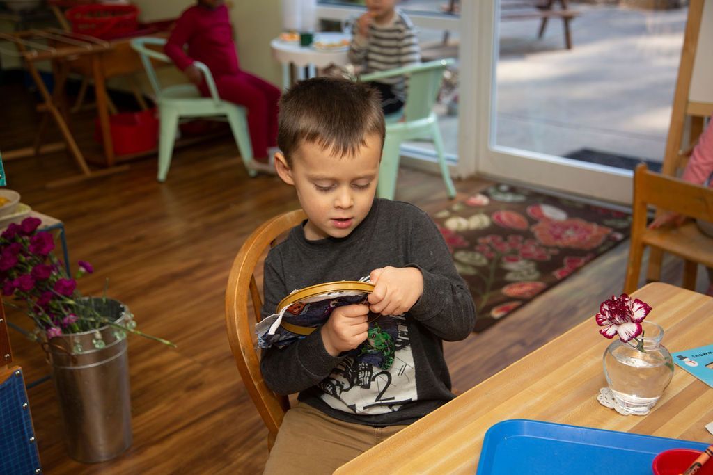 Child working with Montessori practical life materials