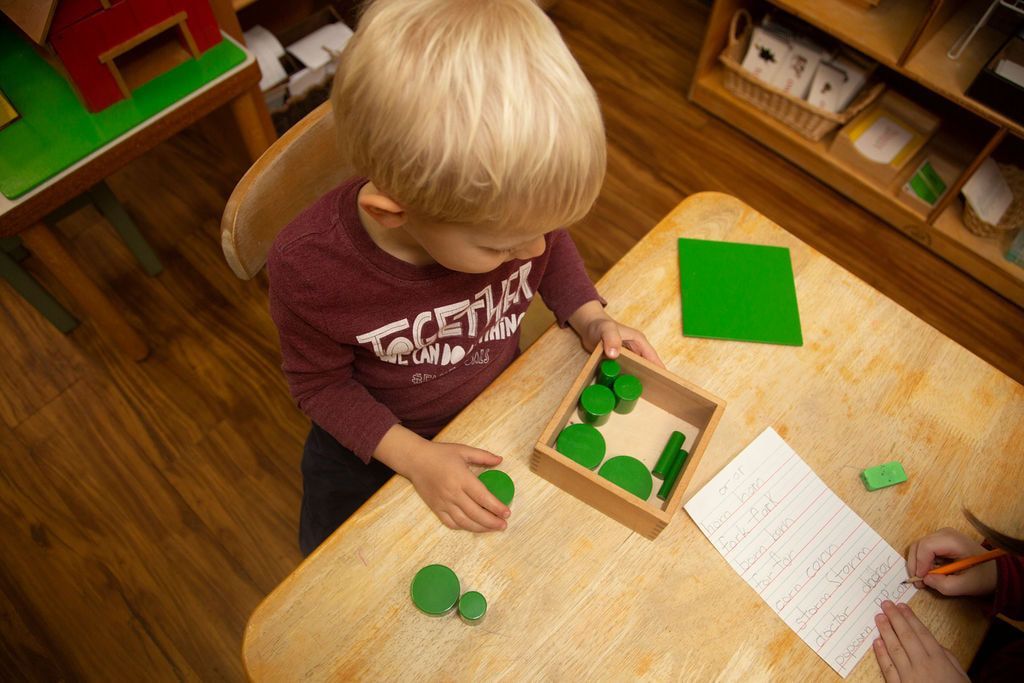 Child working with Montessori sensorial materials