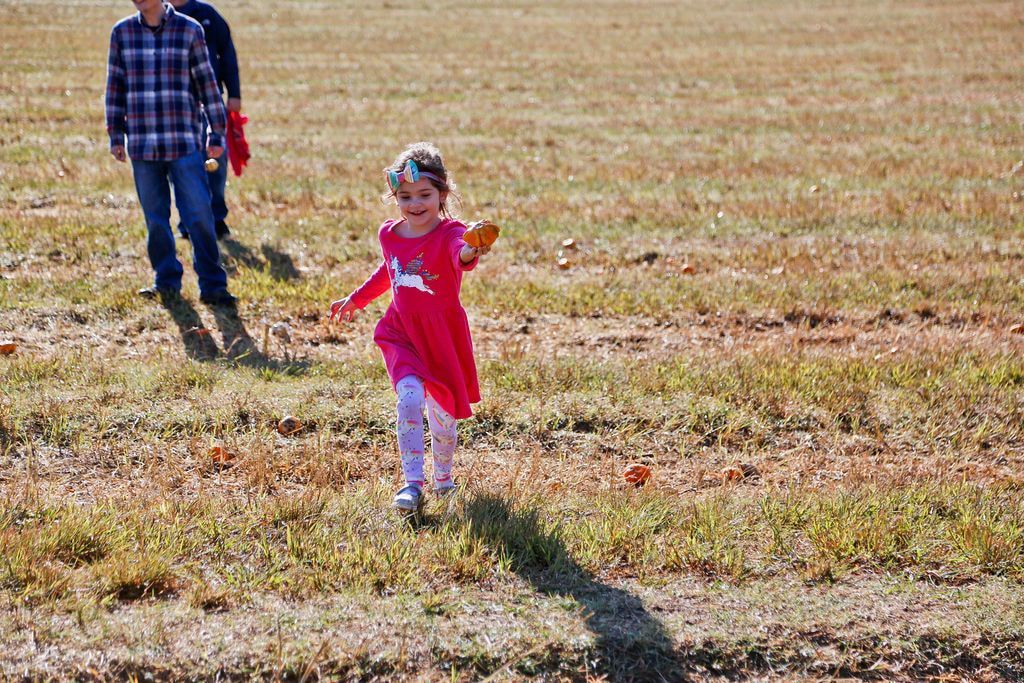 Montessori child running across a field