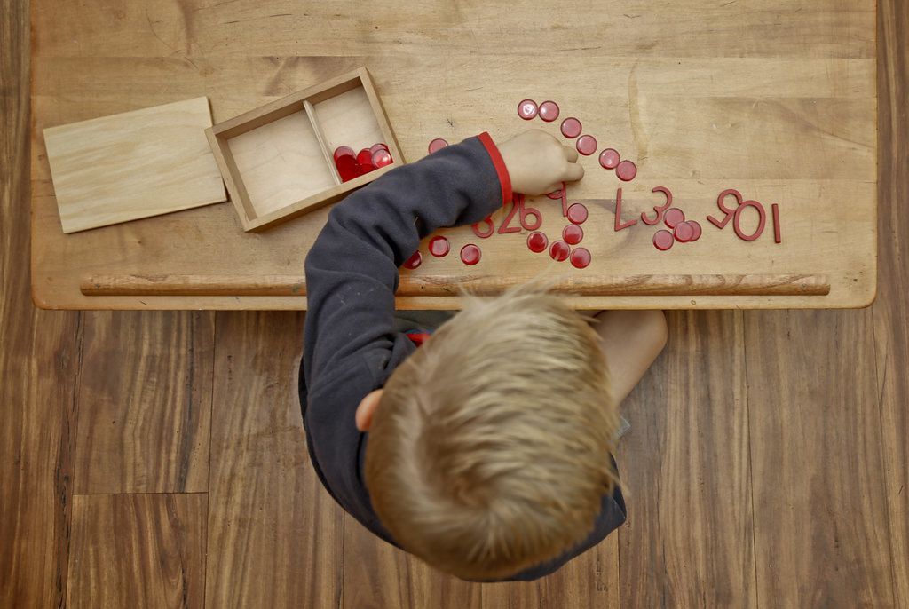 Montessori child working with math materials