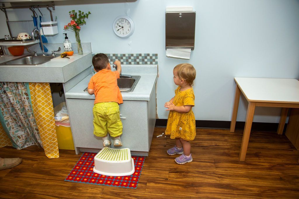 Montessori children washing their hands