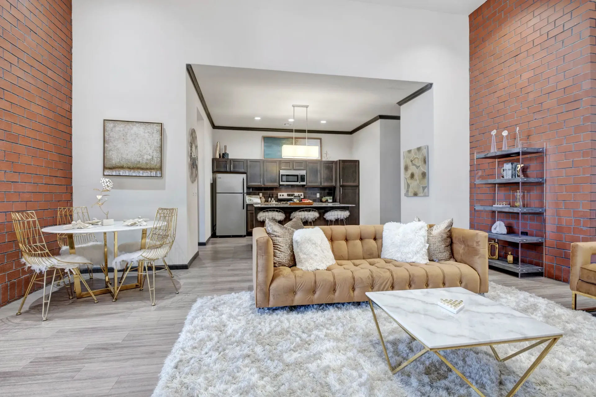 A living room with a couch , table , chairs and rug.
