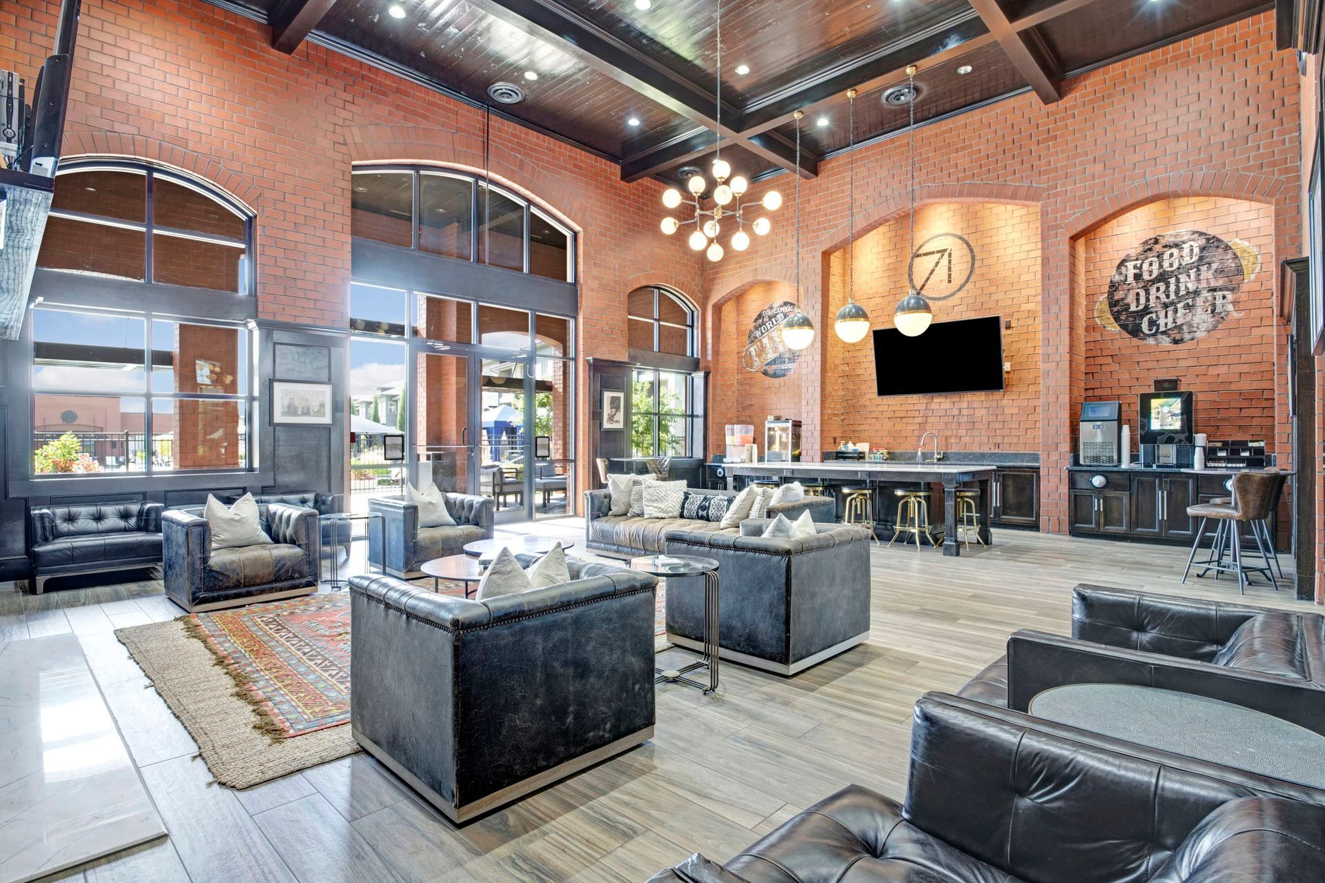 A large living room filled with furniture and a brick wall.