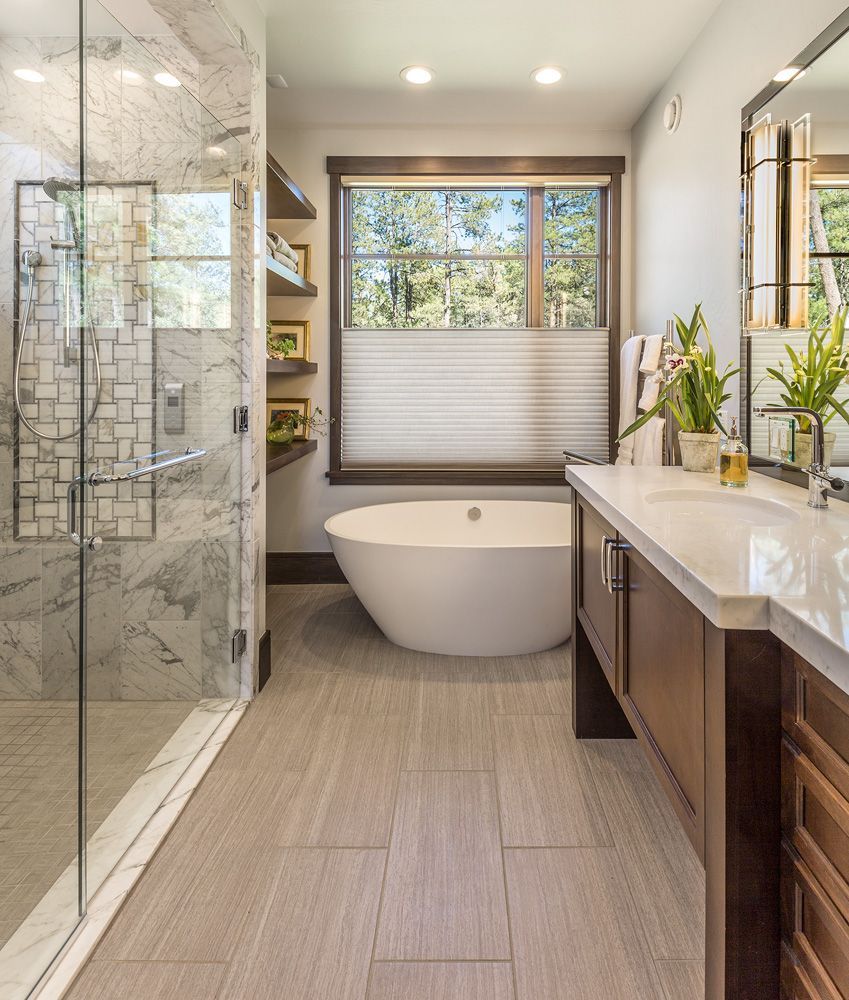 A bathroom with a bathtub and a walk in shower
