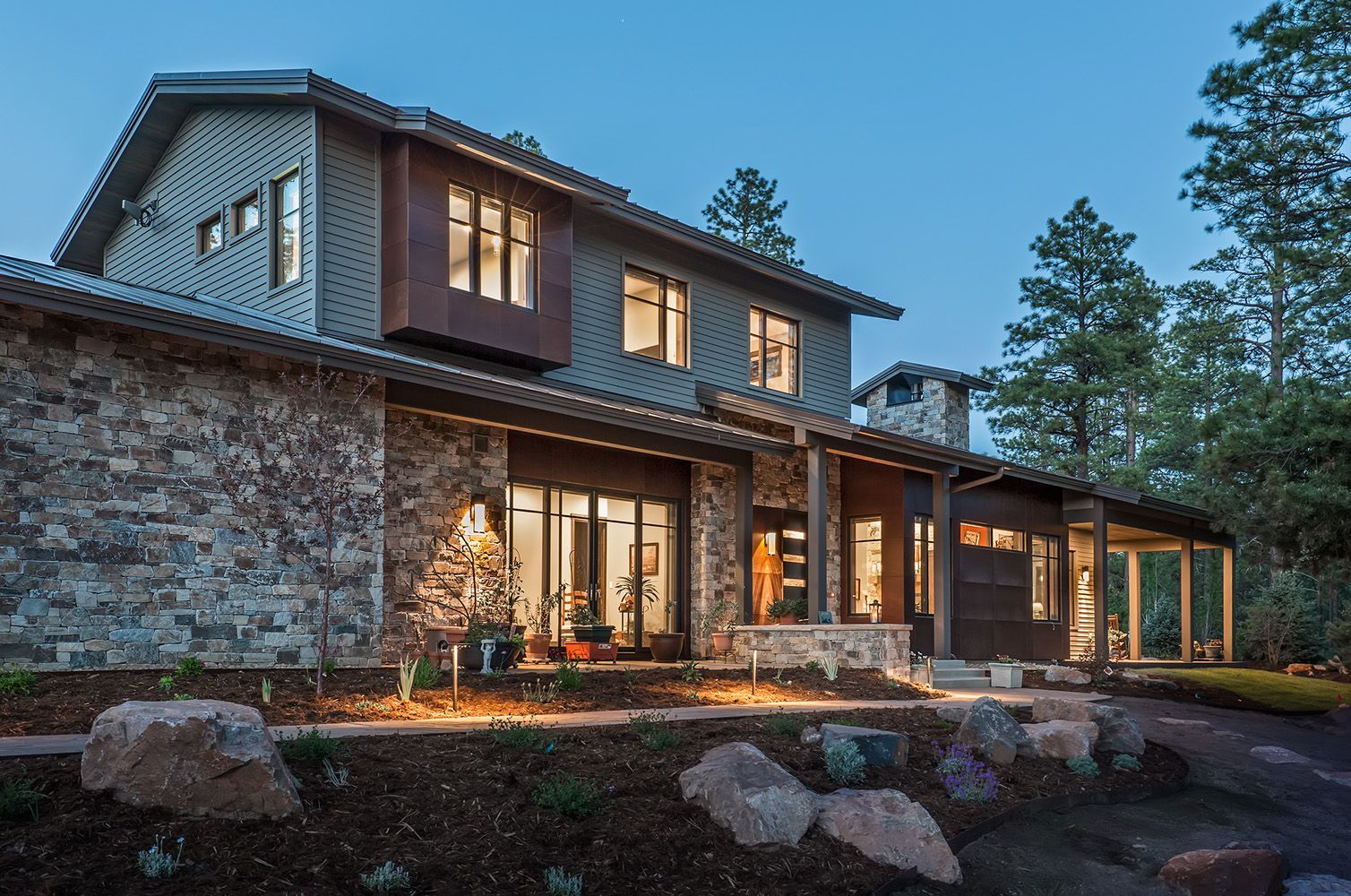 A large house with a lot of windows and trees in the background