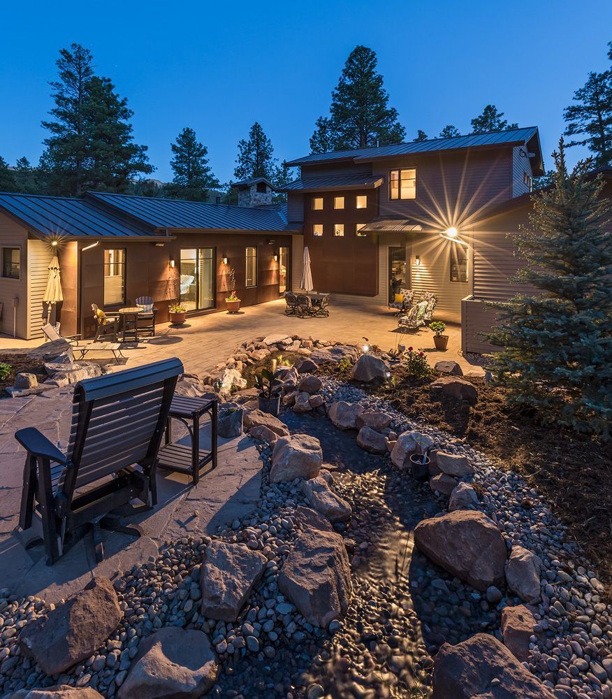 The backyard of a house with a stream running through it