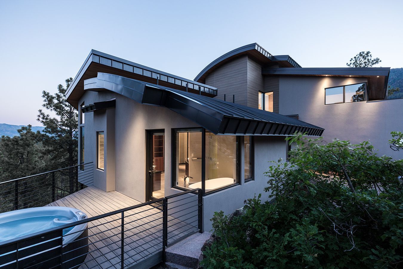 A large house with a hot tub in front of it.