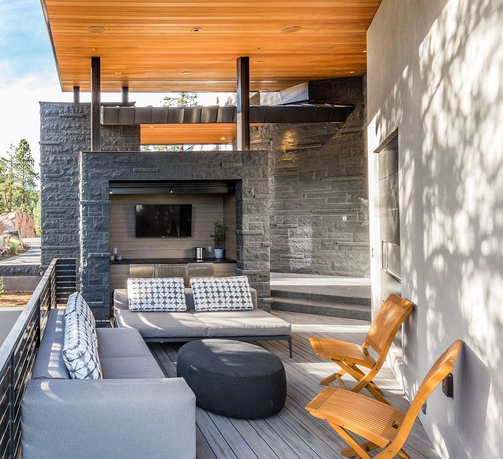 A living room with a couch ottoman and chairs