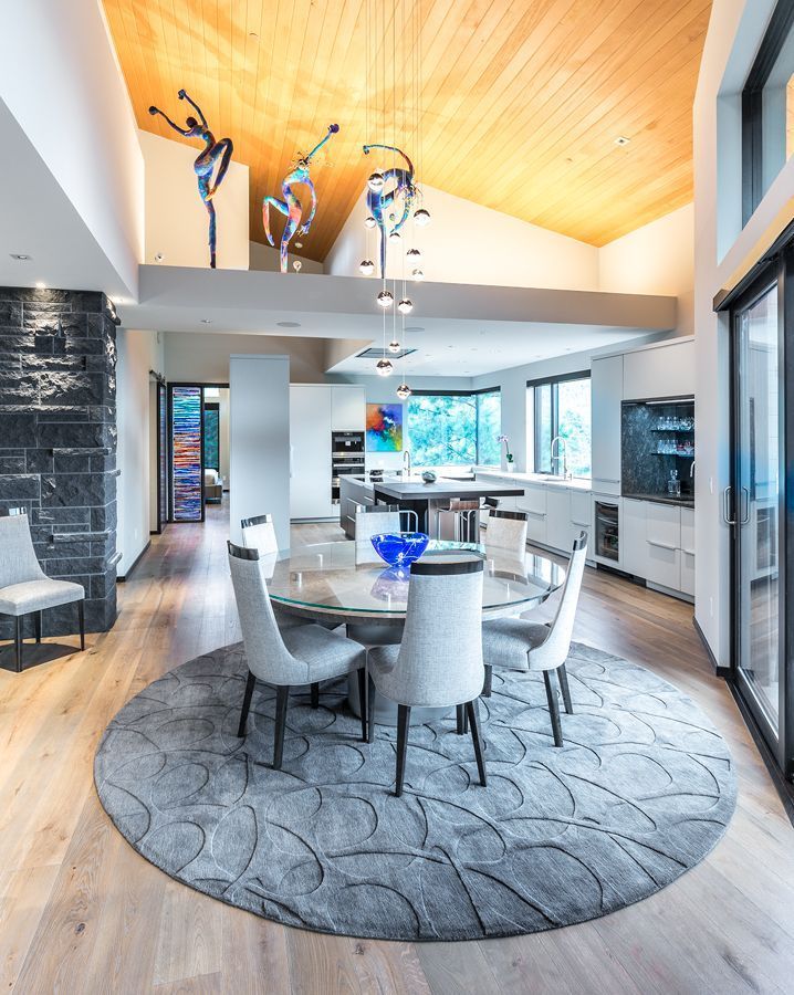 A dining room with a round table and chairs