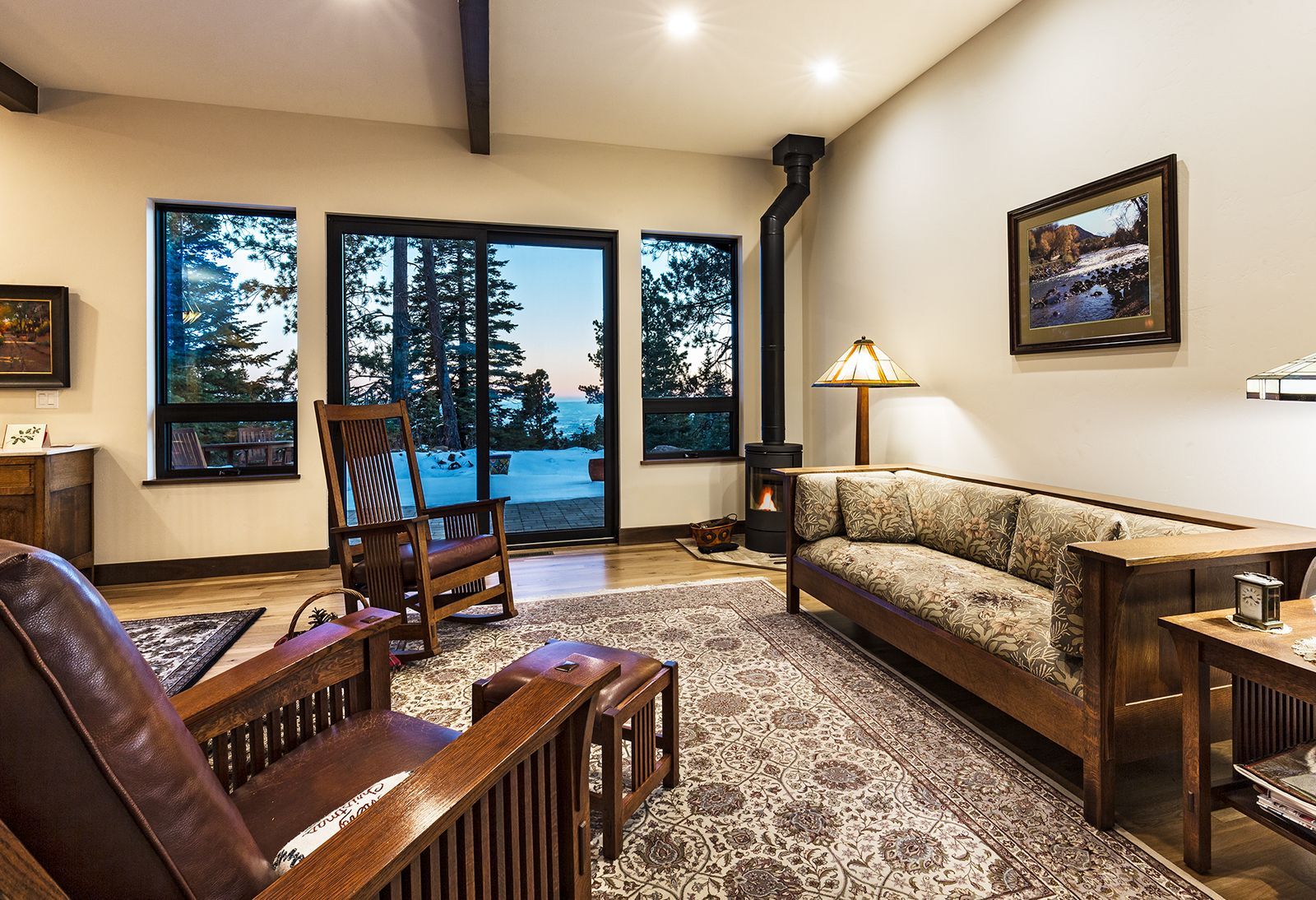 A living room with a couch , chairs , and a fireplace.