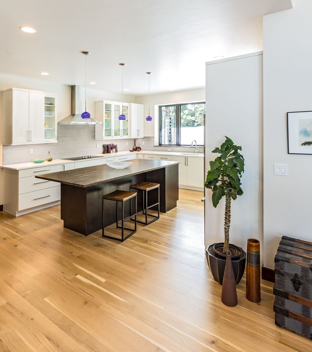 A kitchen with a large island and stools