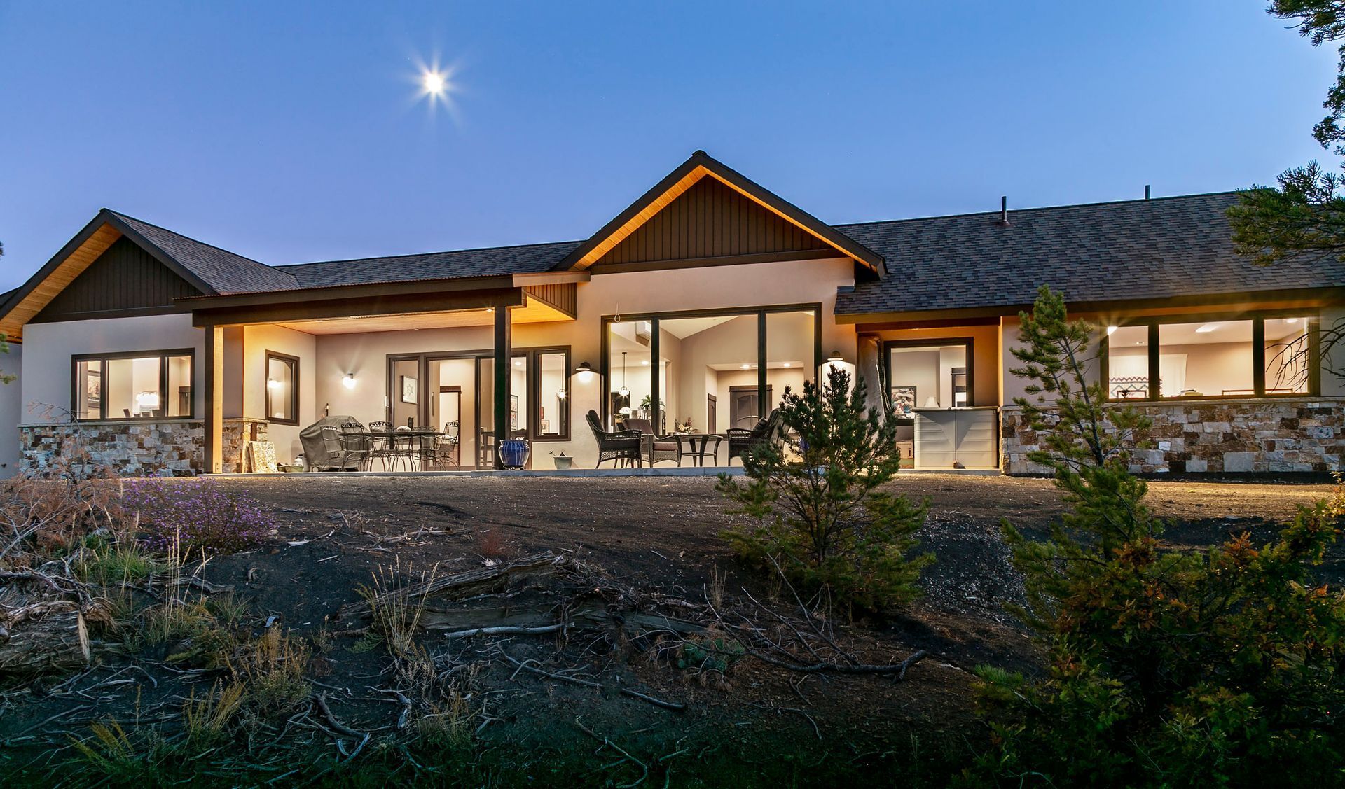 A large house with a lot of windows is lit up at night