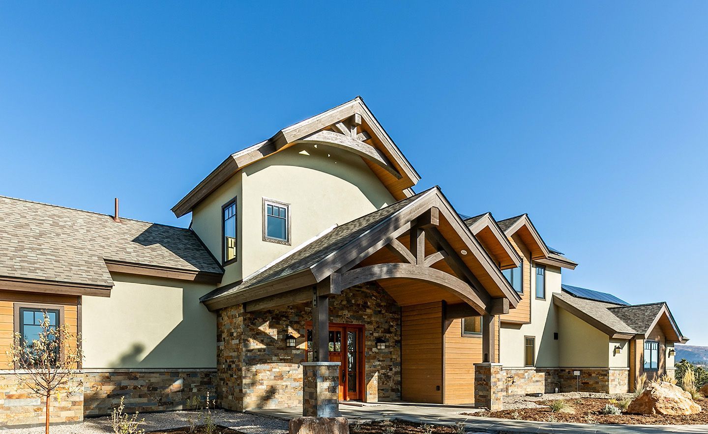 A large house with a lot of windows and a blue sky in the background.