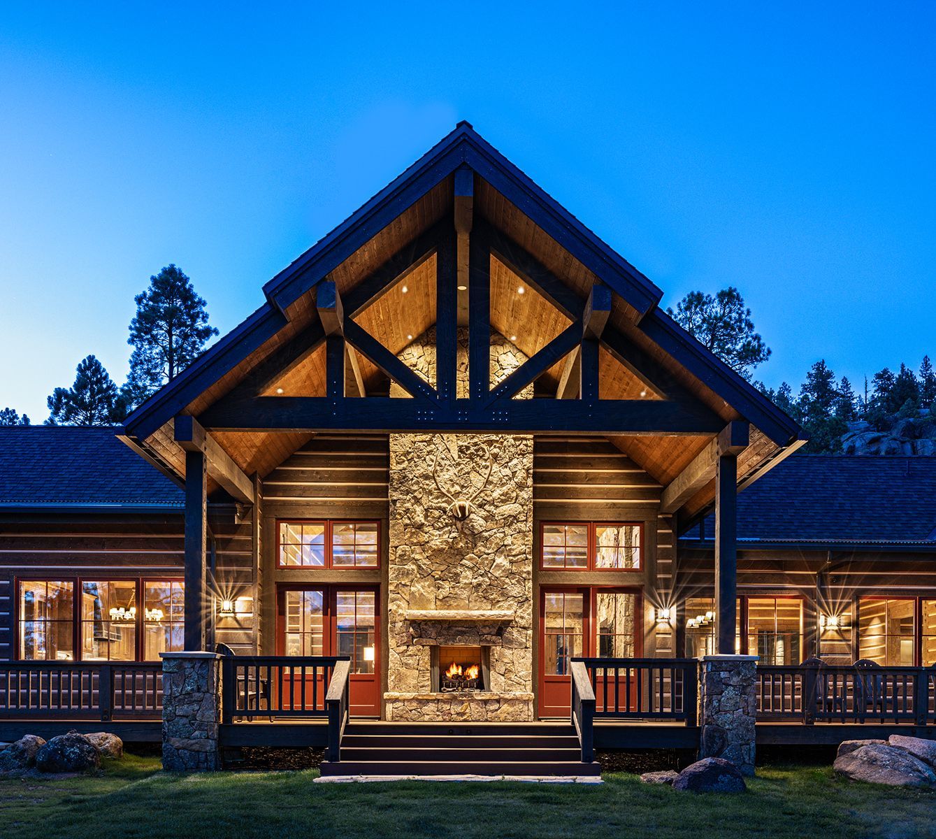 A living room in a log cabin with wooden floors and a fireplace.