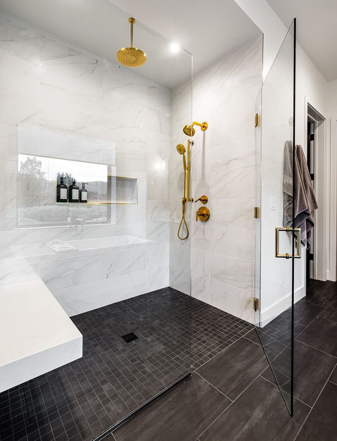 A bathroom with a walk in shower and a sink.