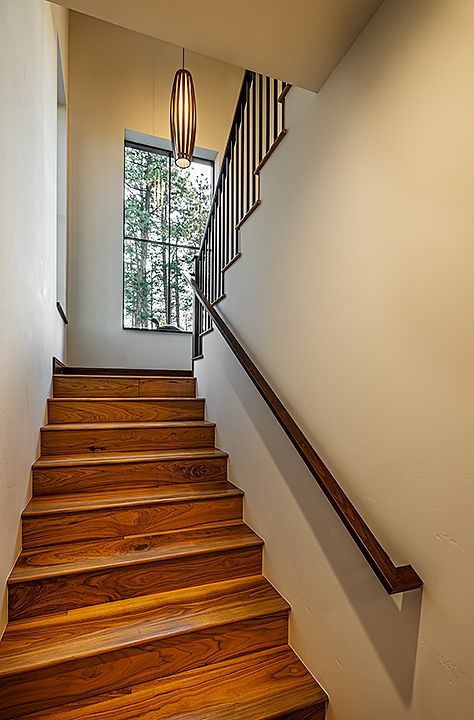 A wooden staircase leading up to the second floor of a house.
