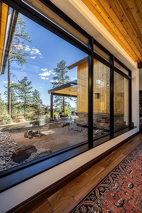 A house with a lot of windows and a rug on the floor.