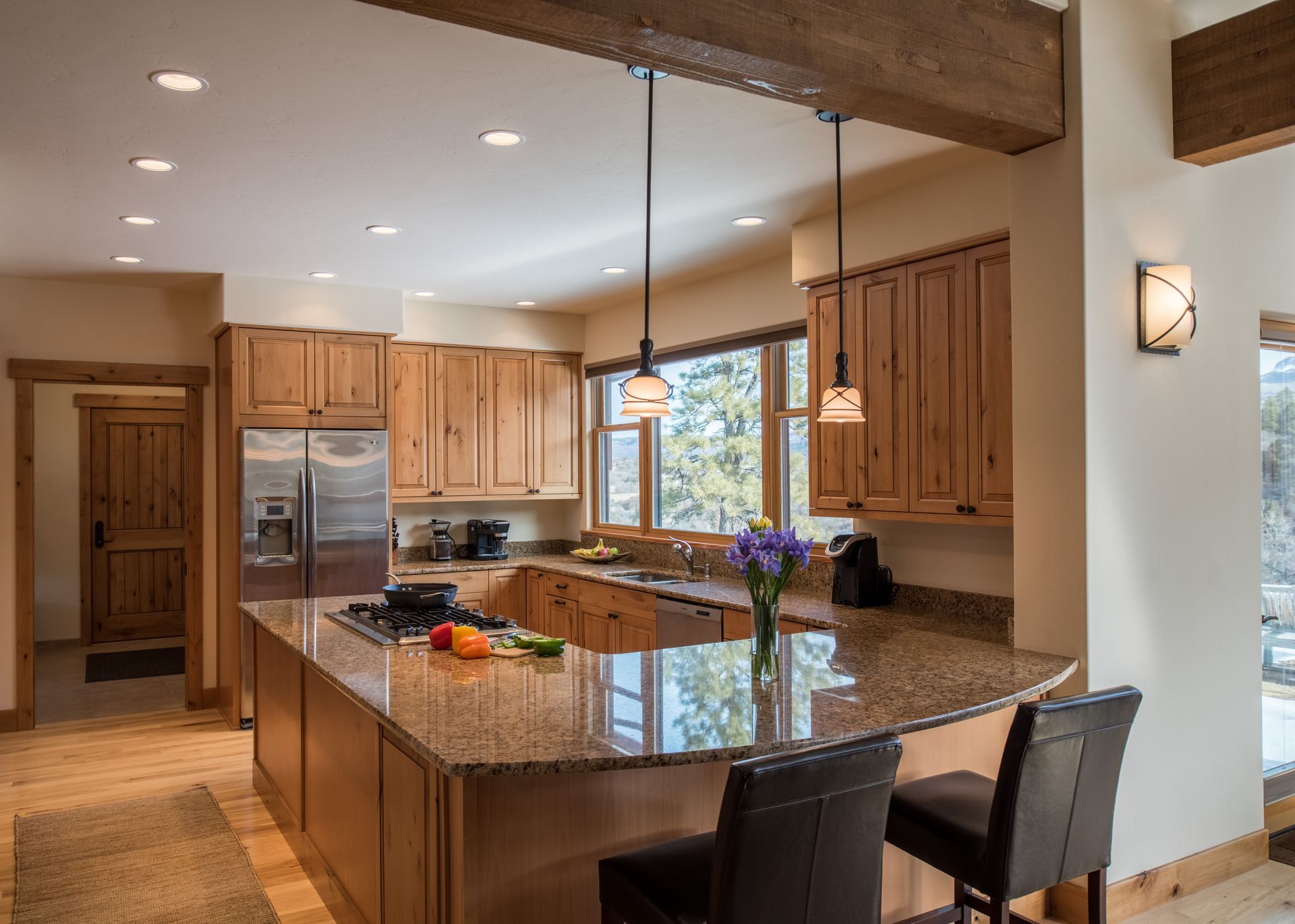 A kitchen with granite counter tops and wooden cabinets