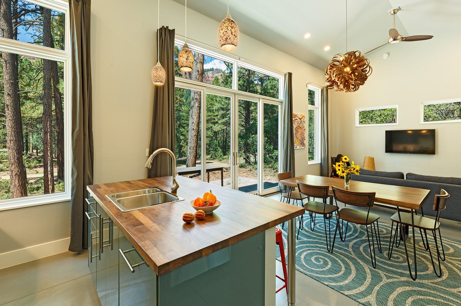 A kitchen with a large island and a dining table