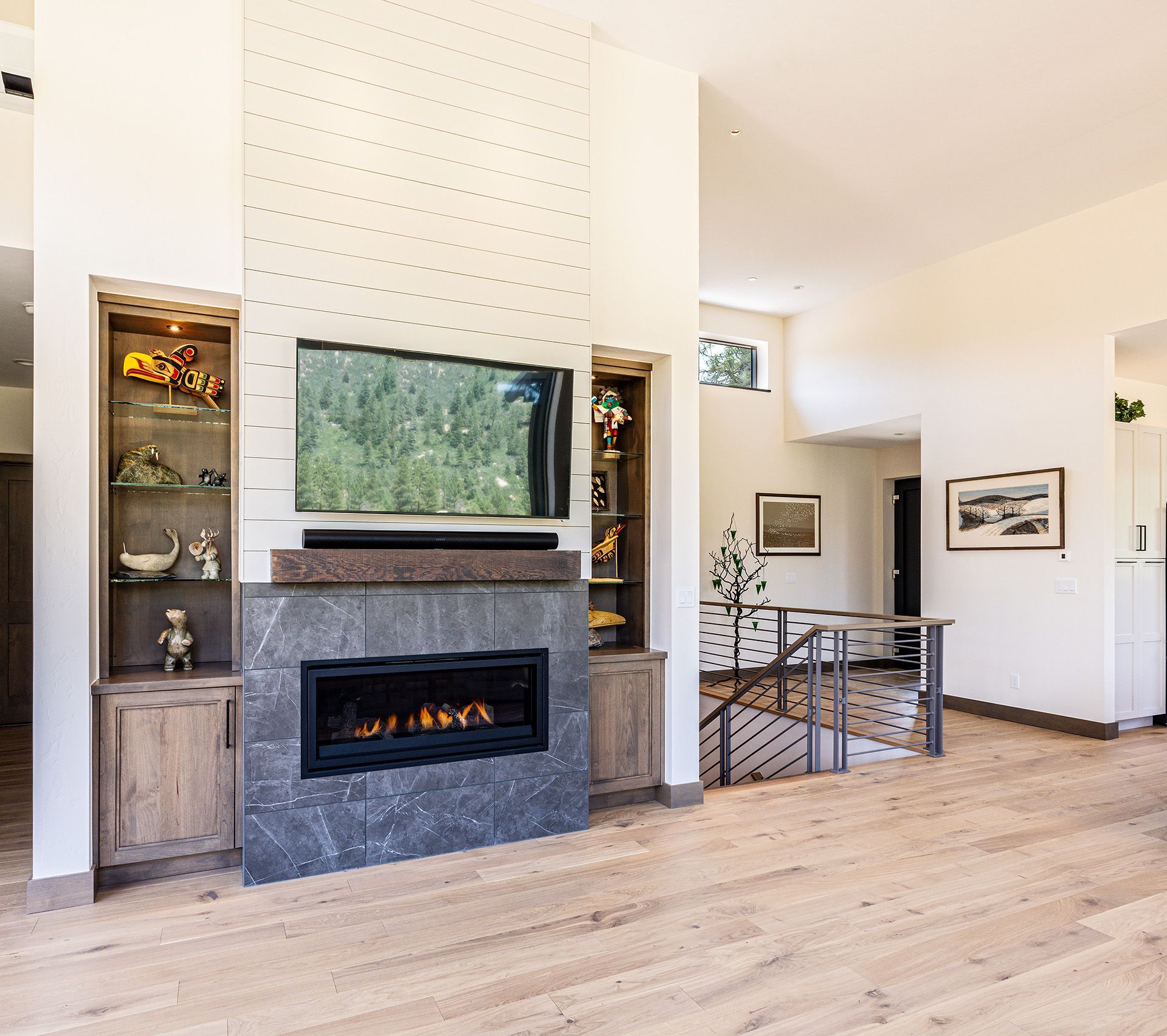 A living room with a fireplace and a flat screen tv