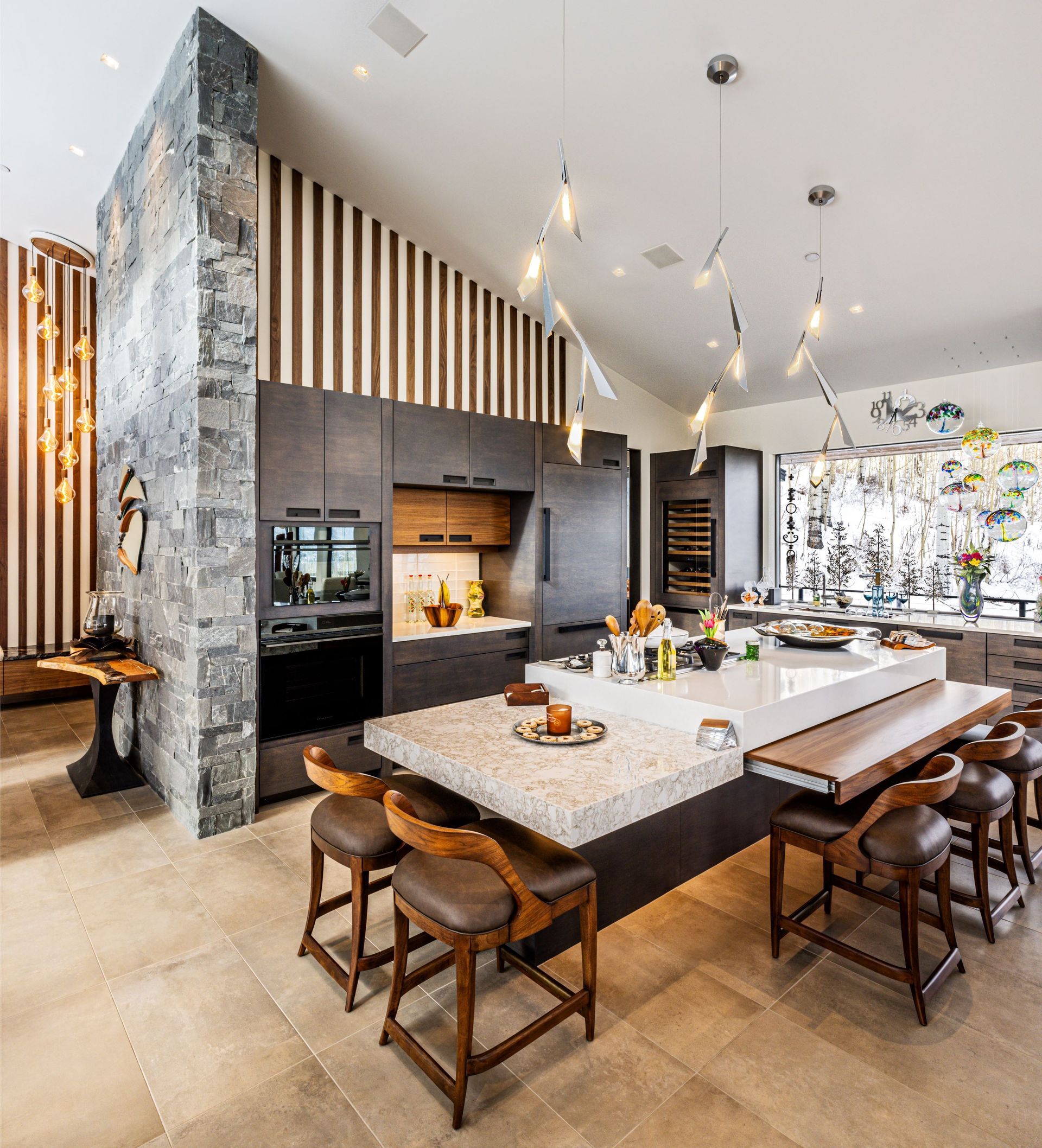 A large kitchen with a table and chairs in it.