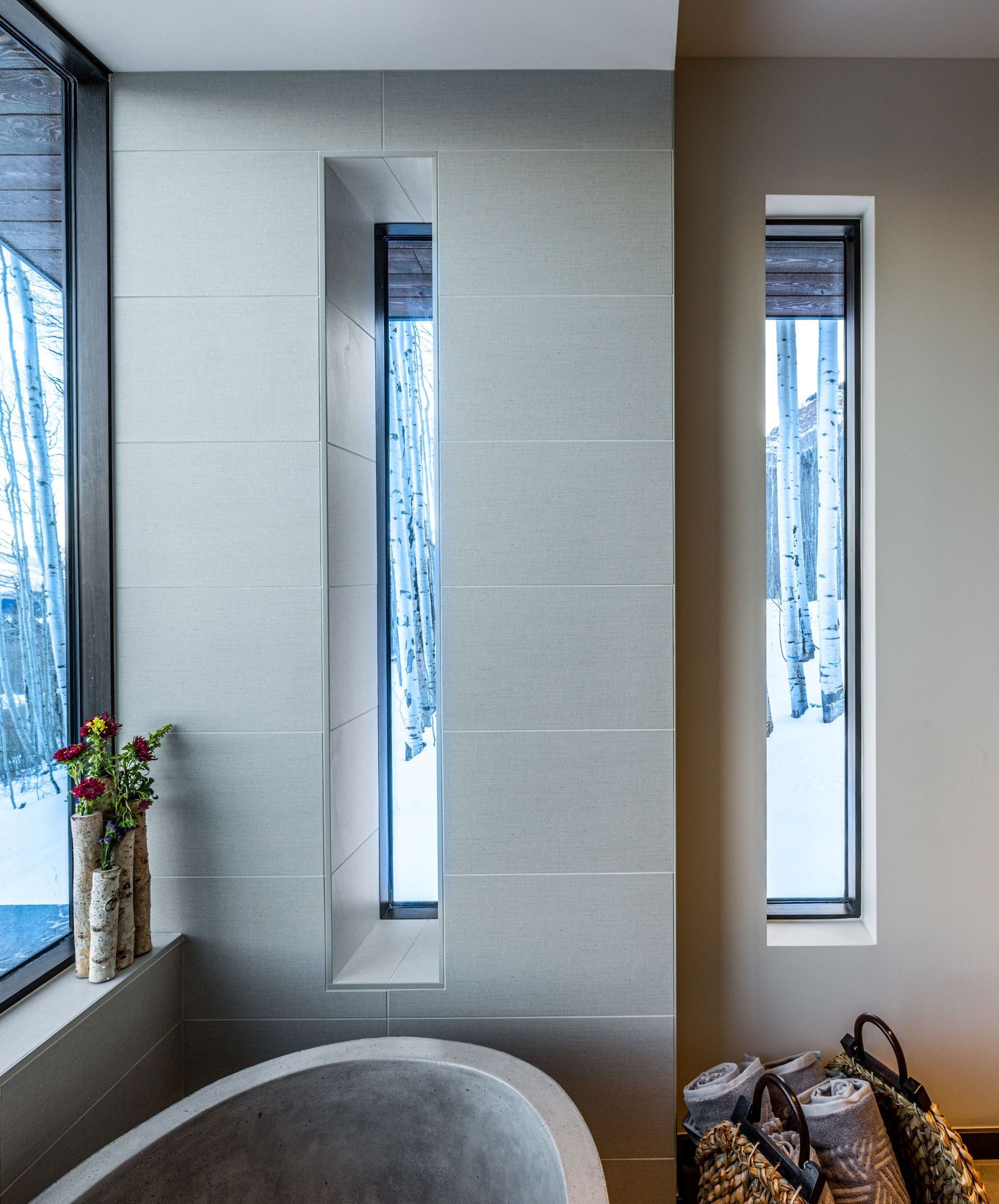 A bathroom with a large tub and two windows