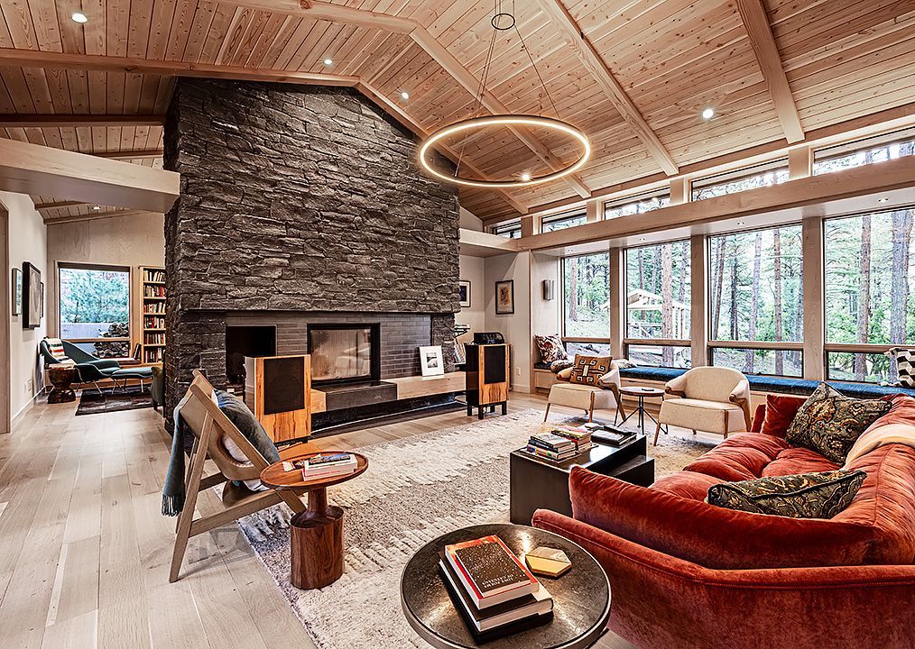 A living room with a couch , chairs , and a fireplace.