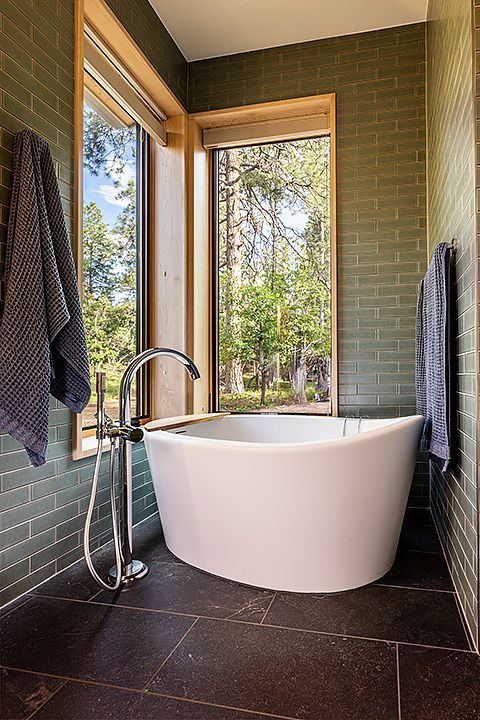 A bathroom with a large tub and a window.