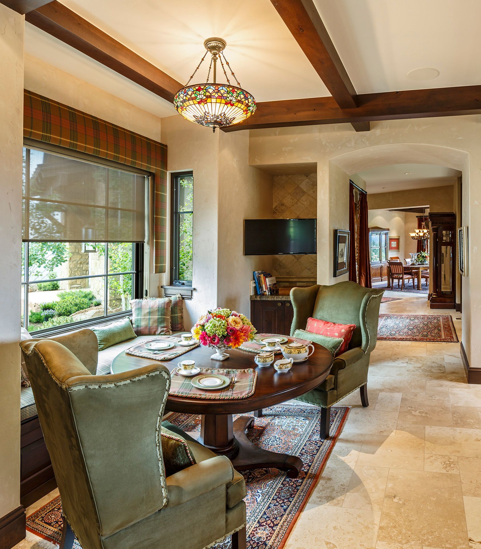 A living room with a table and chairs and a television