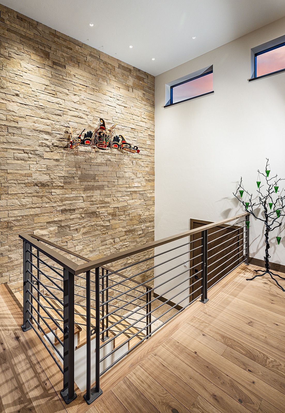 A staircase with a wooden railing and a brick wall.