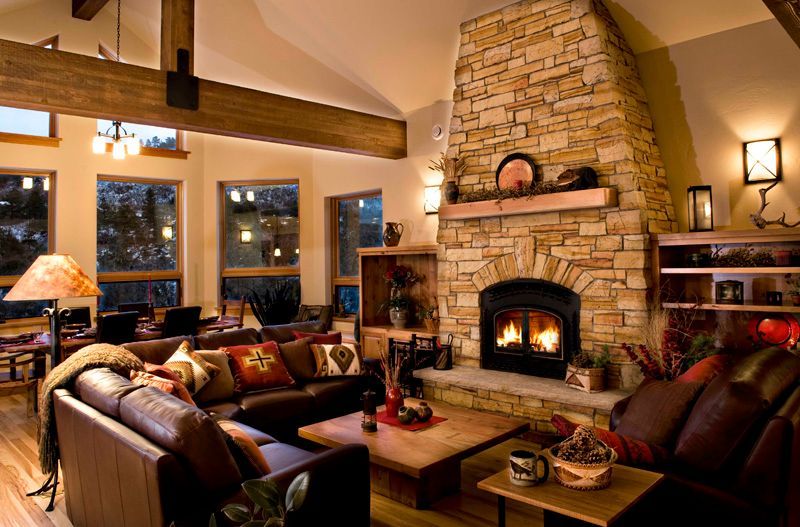 A living room with a stone fireplace and a couch