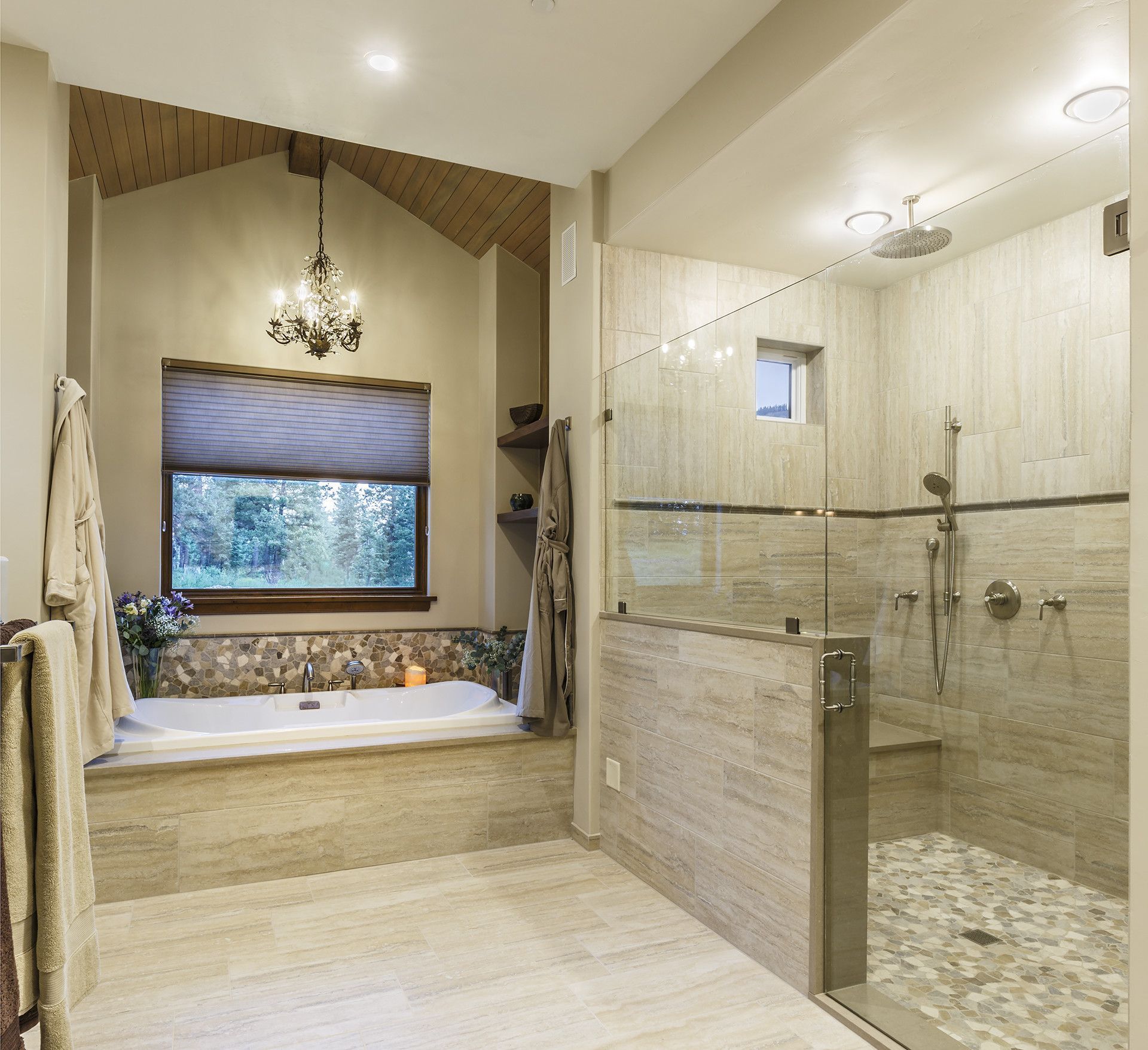 A bathroom with a tub and a walk in shower