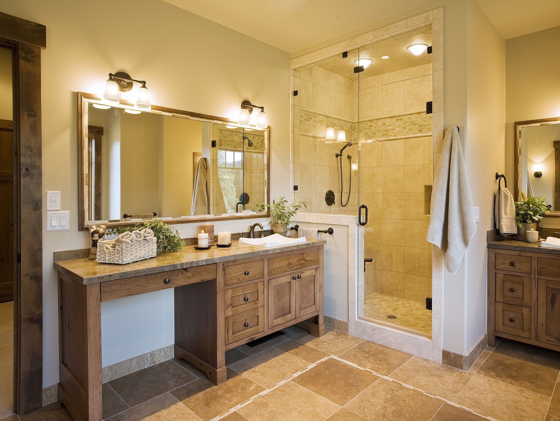 A bathroom with two sinks and a walk in shower.