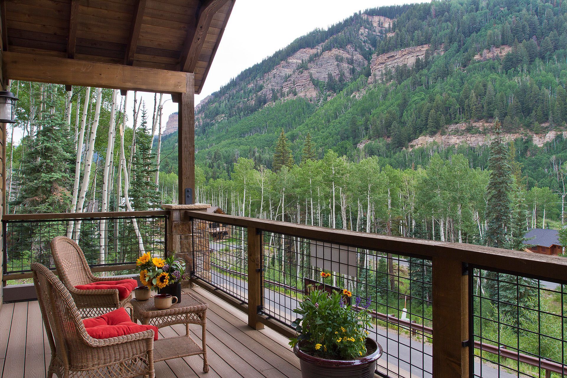 A deck with a view of mountains and trees