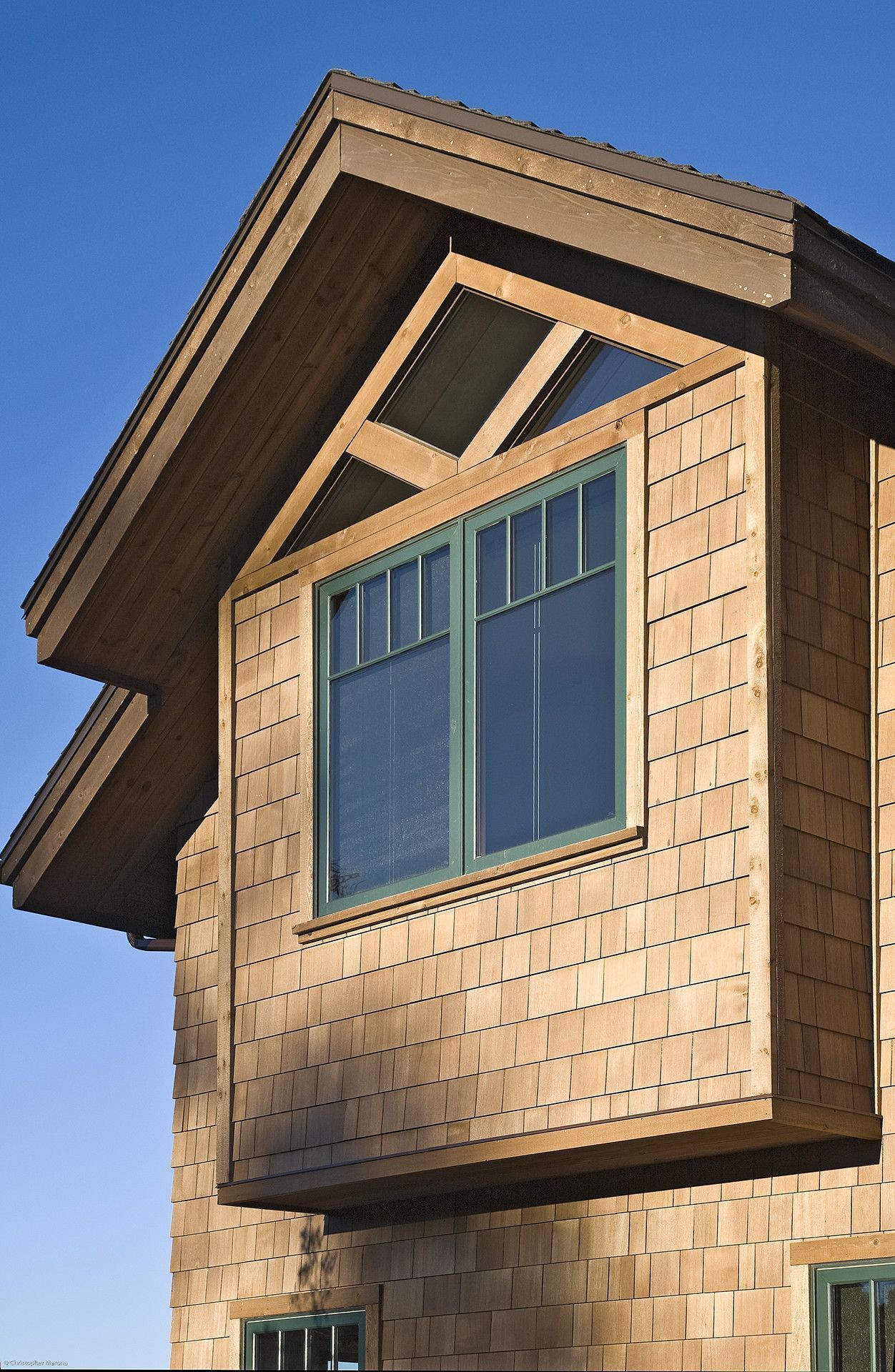 A house with a large window on the side of it